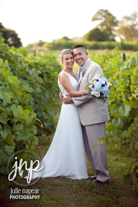 Bride and groom in the vines at Veramar Vineyard Wedding in Berryville, VA by Julie Napear Photography
