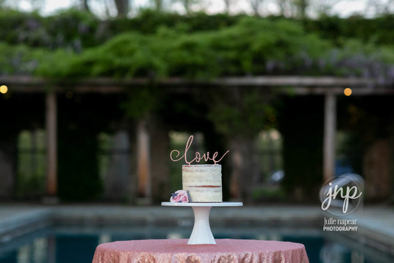 Wedding cake in front of the pool at Goodstone Inn, Elopement and Wedding venue in Middleburg, VA